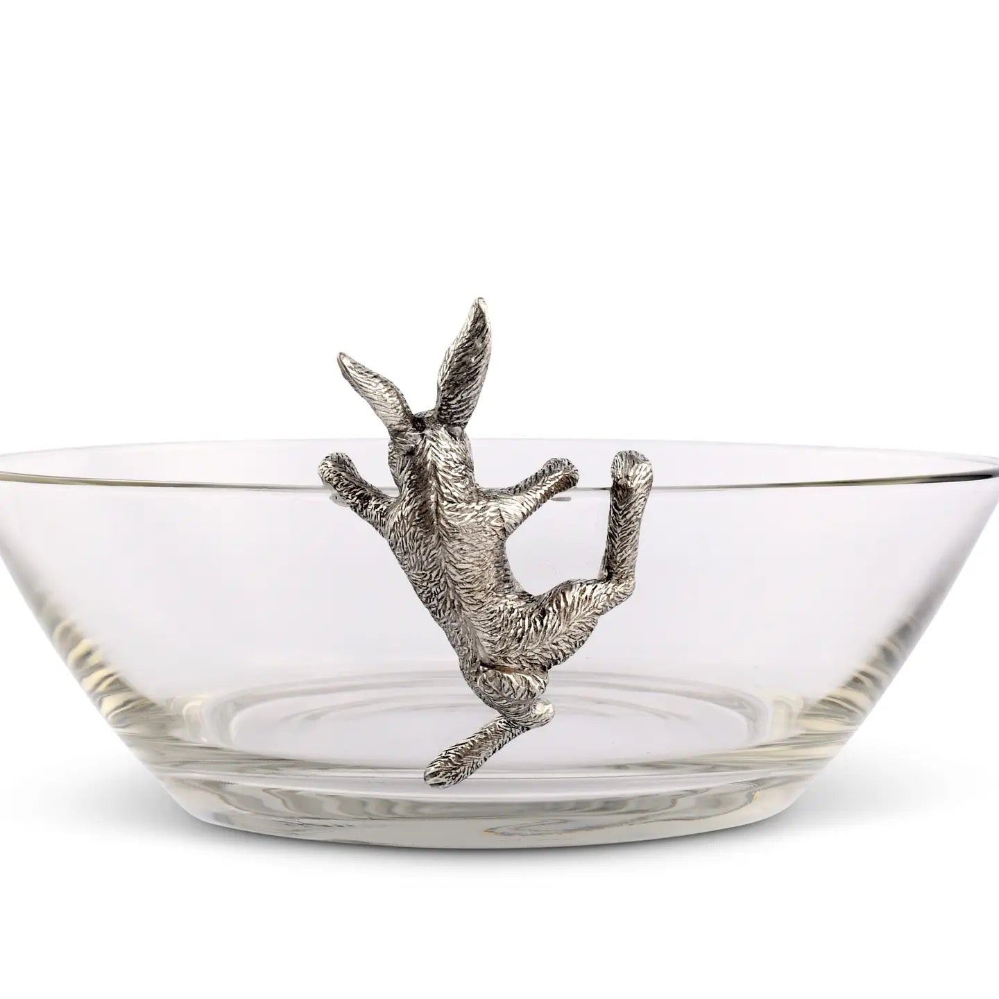 Clear glass bowl with a silver deer head finial on a white background