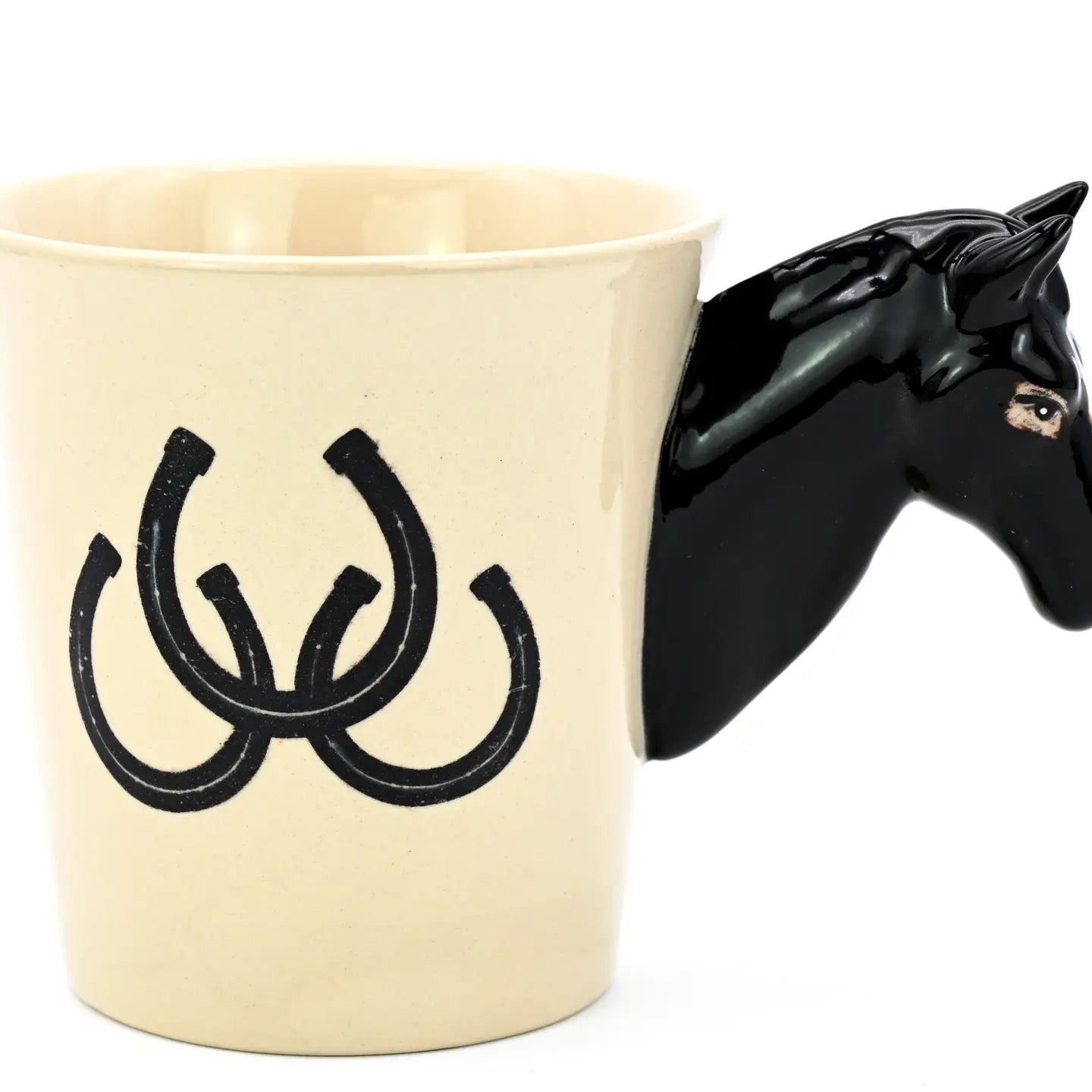 Beige mug with black horse design and horseshoe symbol on a white background