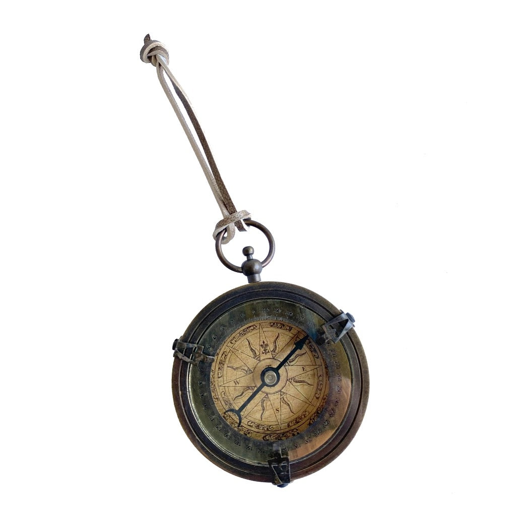 Vintage-style compass with a metallic handle on a white background