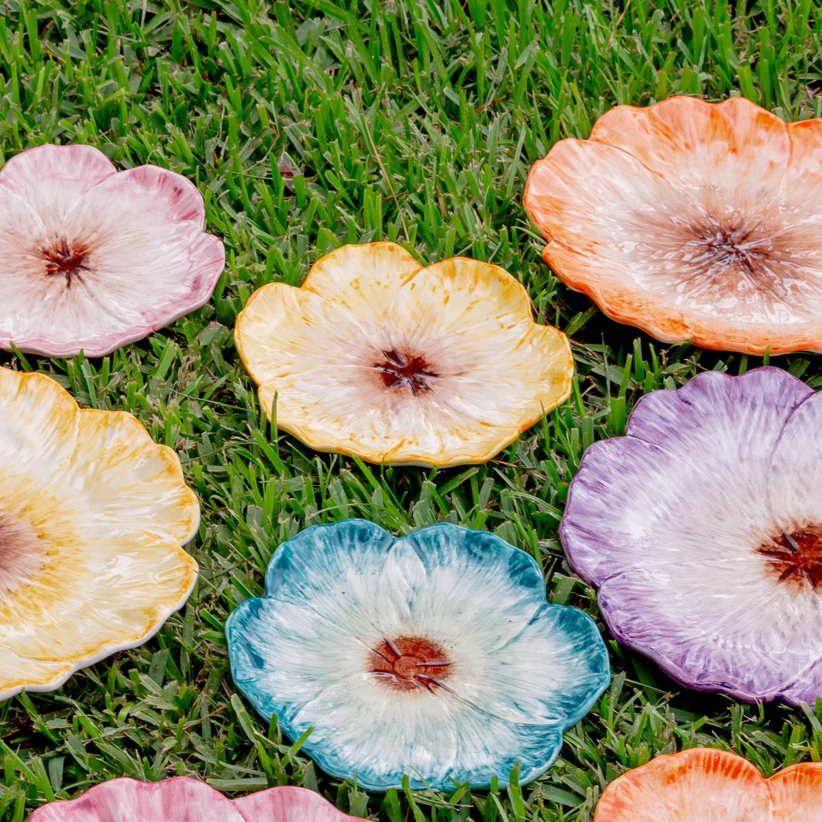 Colorful artificial flowers on grass