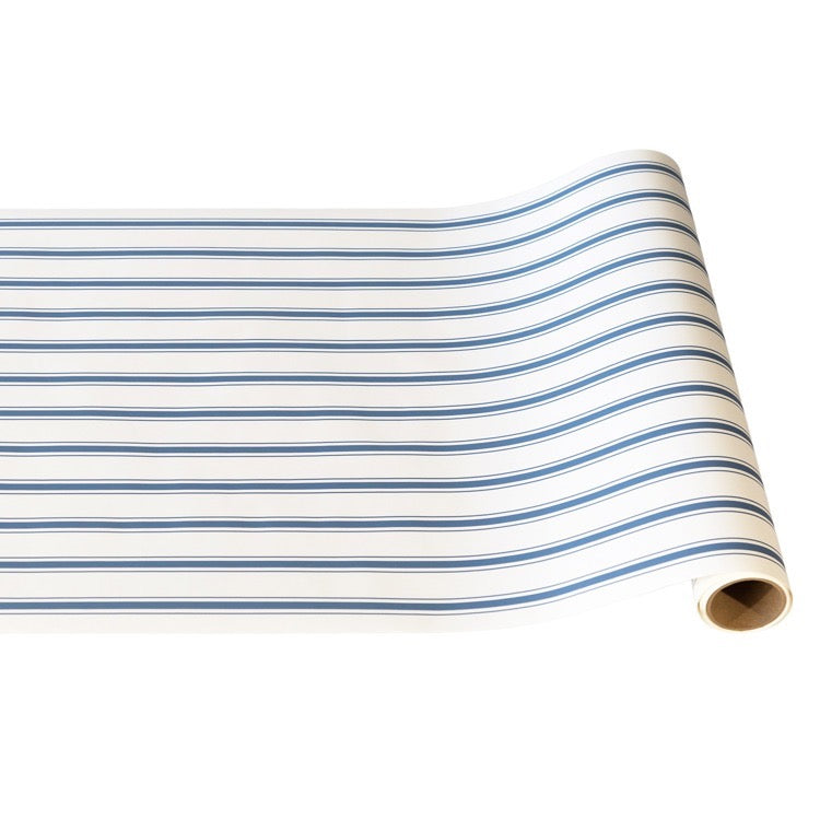 Roll of white fabric with blue stripes on a white background