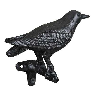 Black cast iron bird decorative item on a white background