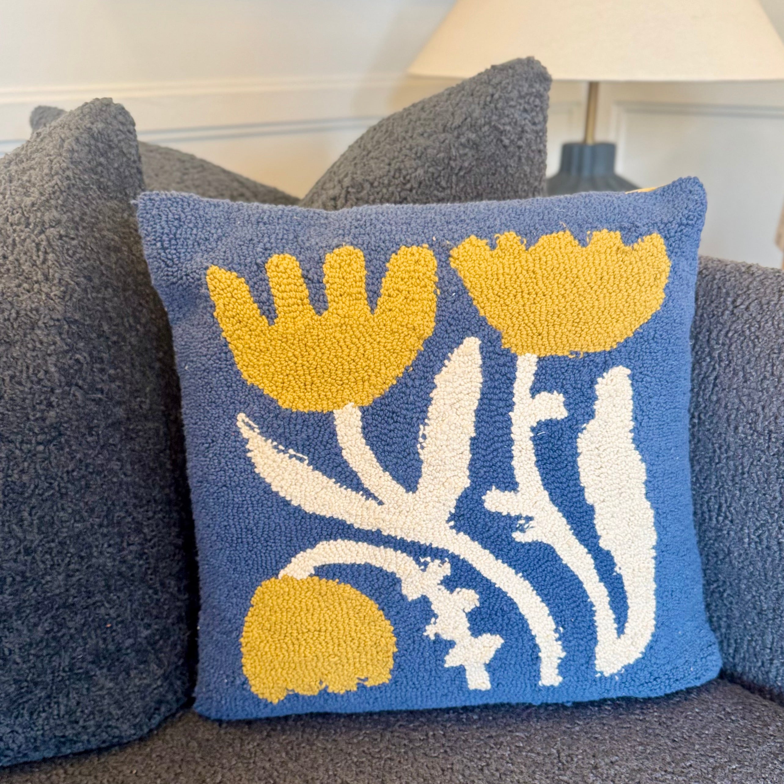 Decorative pillow with floral pattern on a couch