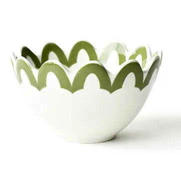 White bowl with green wavy rim on a white background