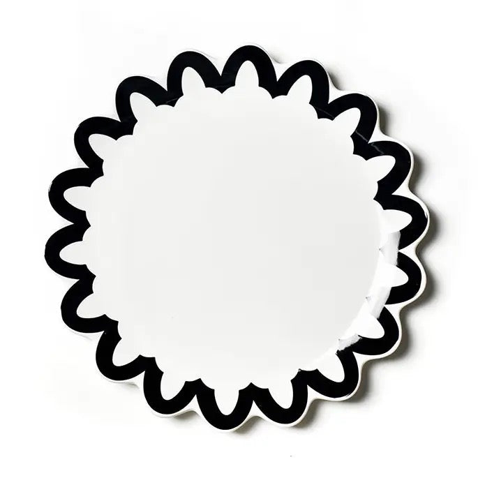 White circular object with black decorative border on a white background