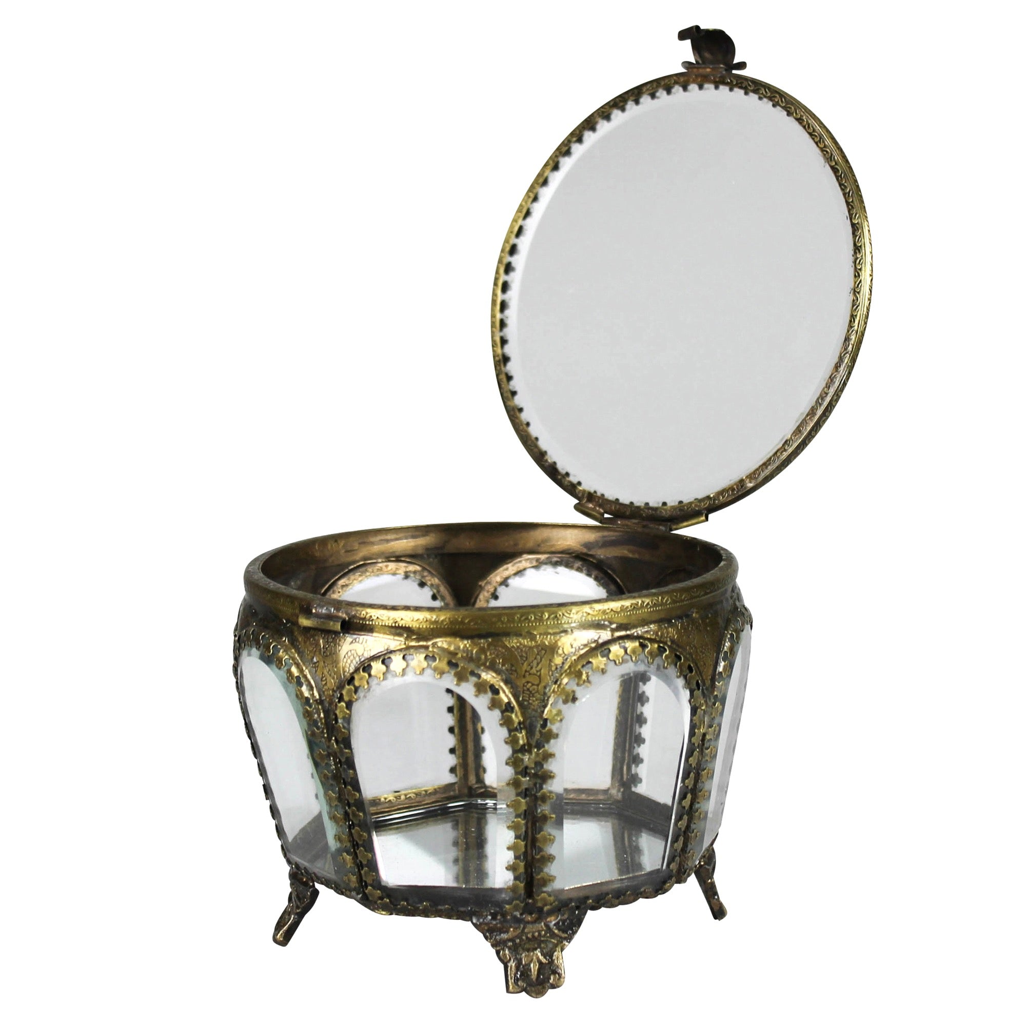 An ornate round jewelry box with an open lid, featuring a gold-toned metal frame, clear glass panels, and a small mirror on the inside of the lid, set against a plain white background.