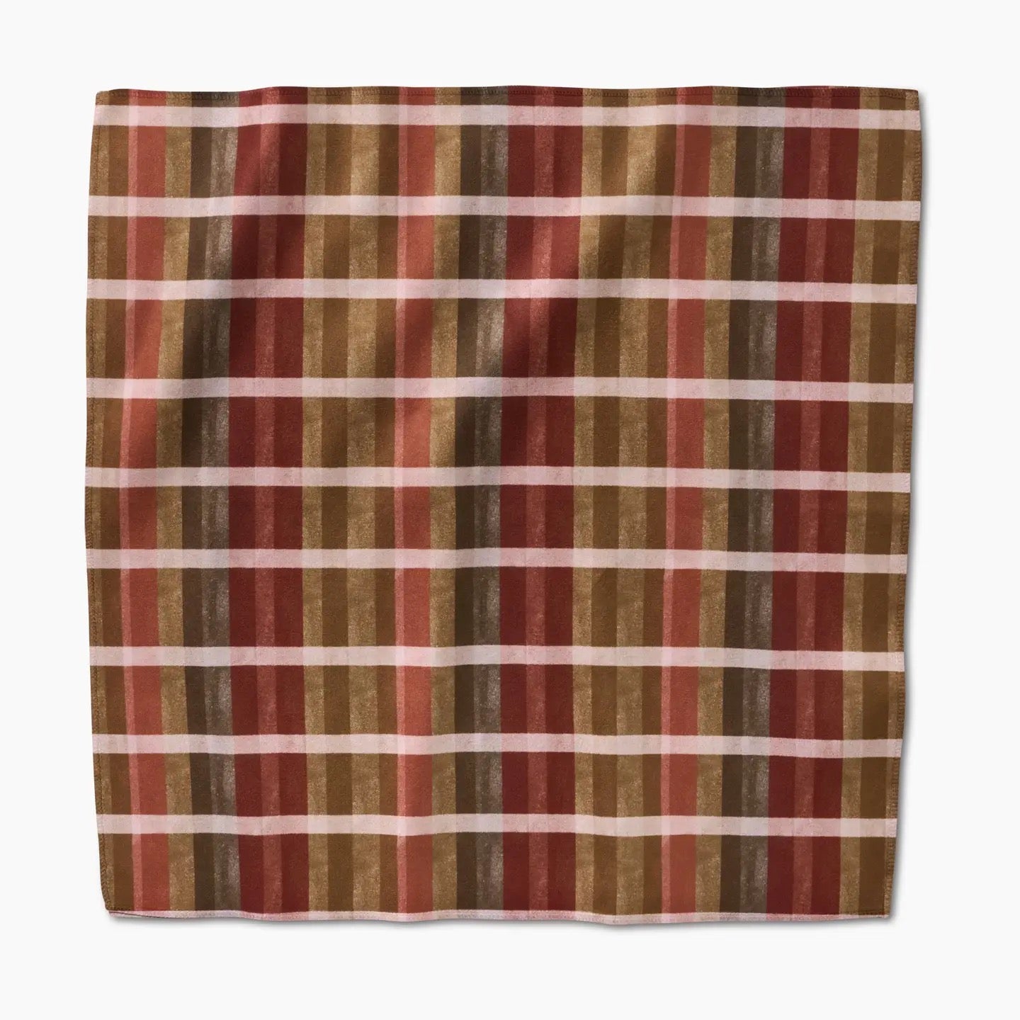 Plaid fabric with red, brown, and beige stripes on a white background