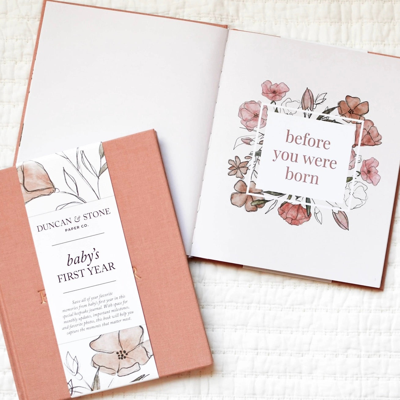 Two greeting cards with floral designs and text on a textured surface