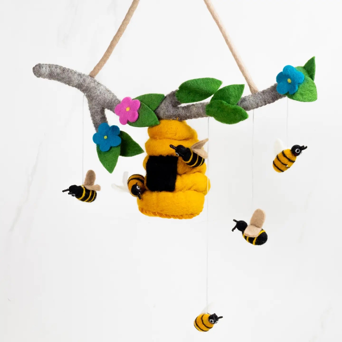 Felt bee and flower mobile with a yellow bee and flowers on a white background