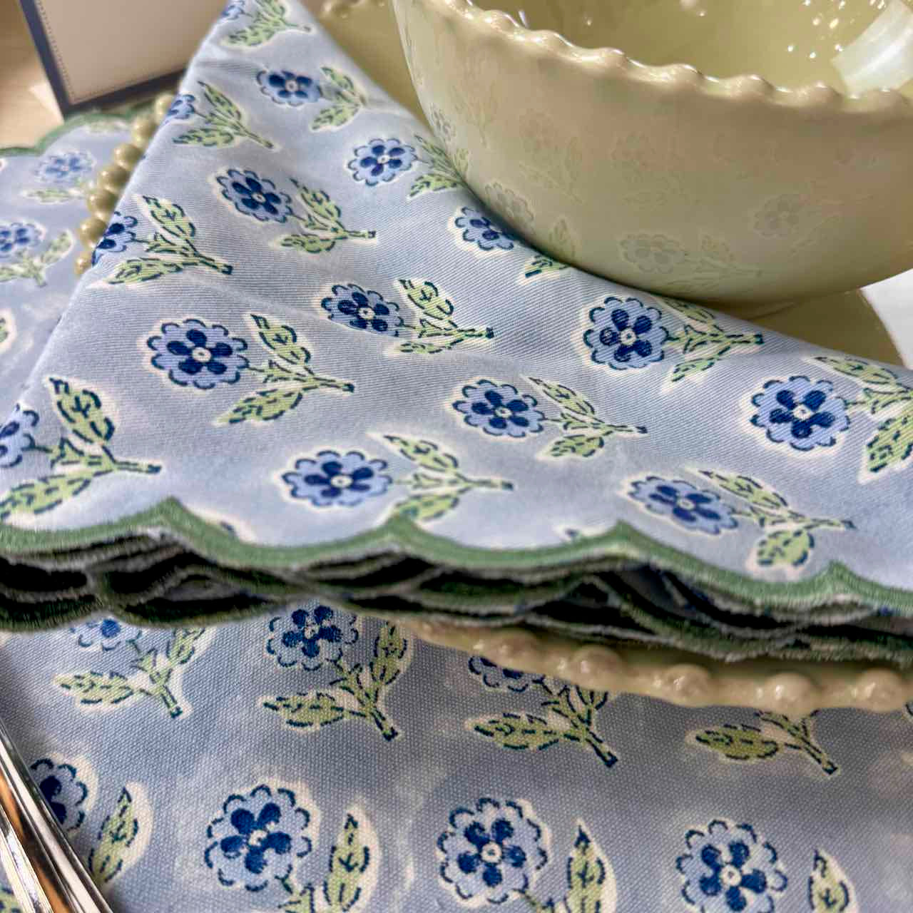 Stack of floral-patterned fabric with a ceramic bowl on top