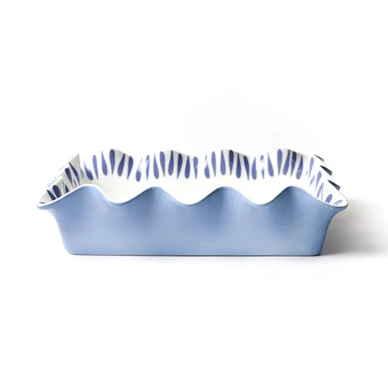 Blue ceramic baking dish with wavy edge on a white background