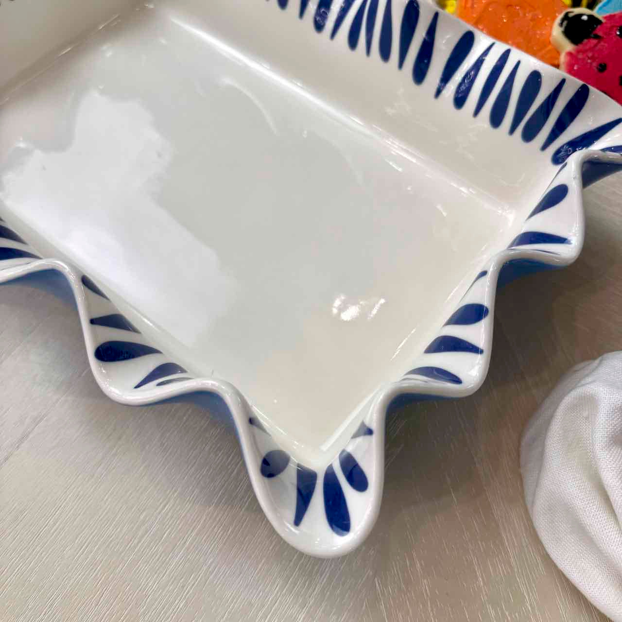 Ceramic dish with blue decorative patterns on a light wooden surface