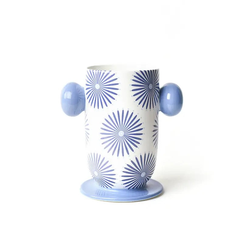 Cylindrical container with blue sunburst pattern and light blue handles on a white background