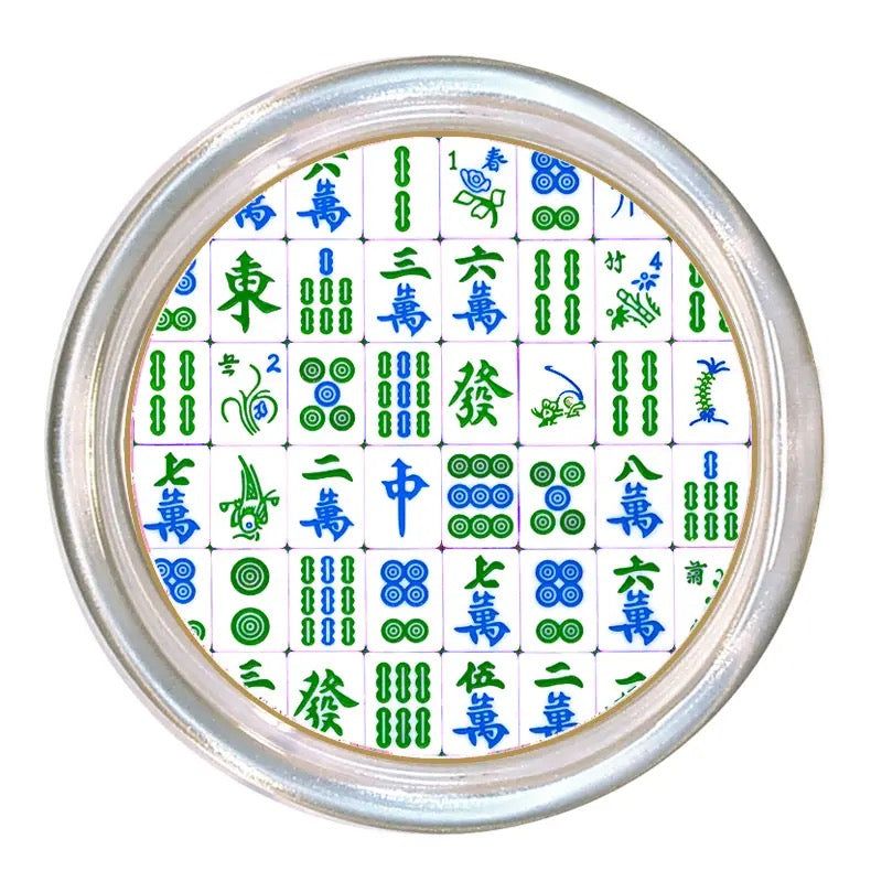 Circular object with Mahjong tile design on a white background