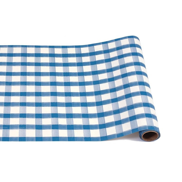 Roll of blue and white checkered fabric on a white background