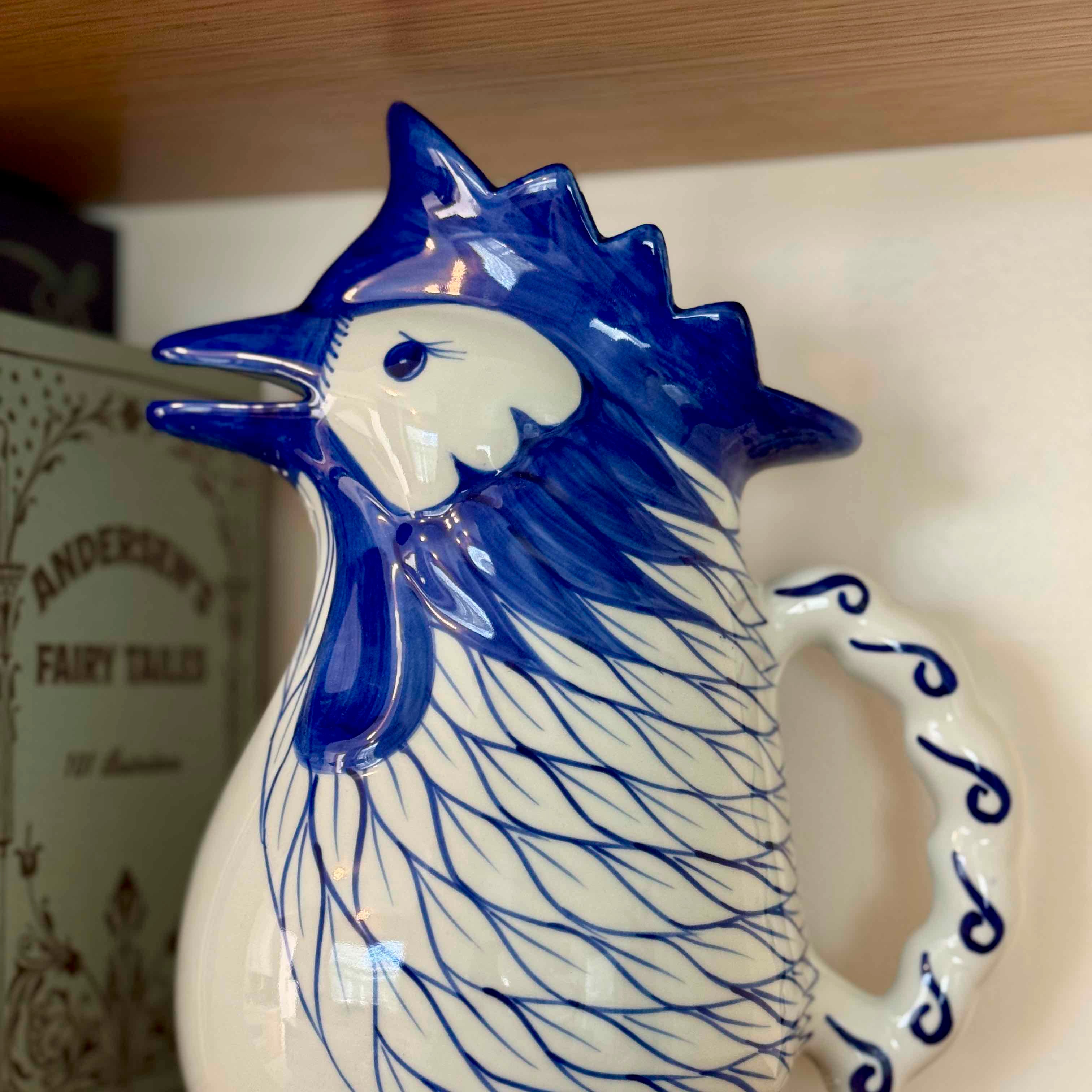 Ceramic rooster with blue accents on a white background