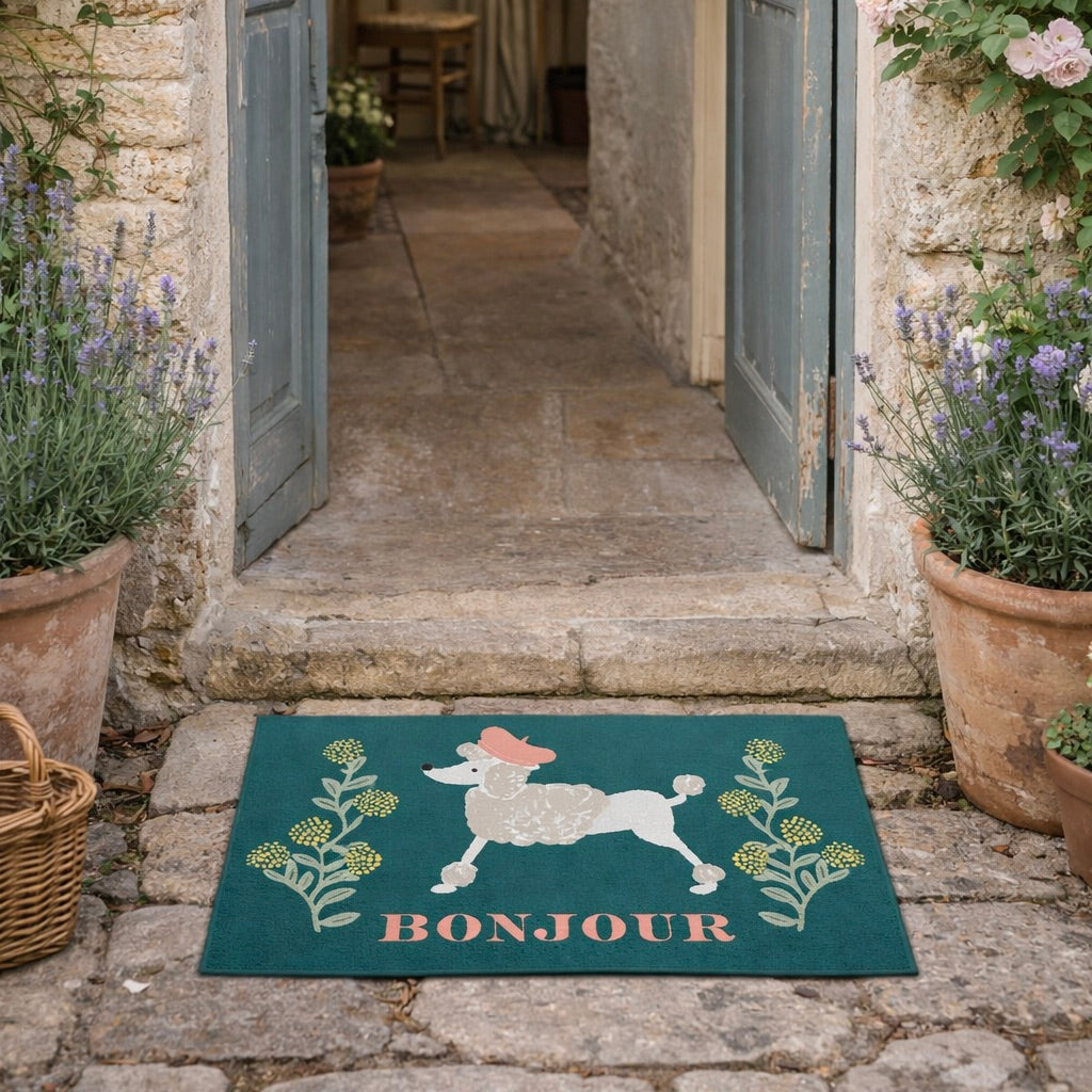 Decorative doormat with a poodle design and 'Bonjour' text on a stone path.