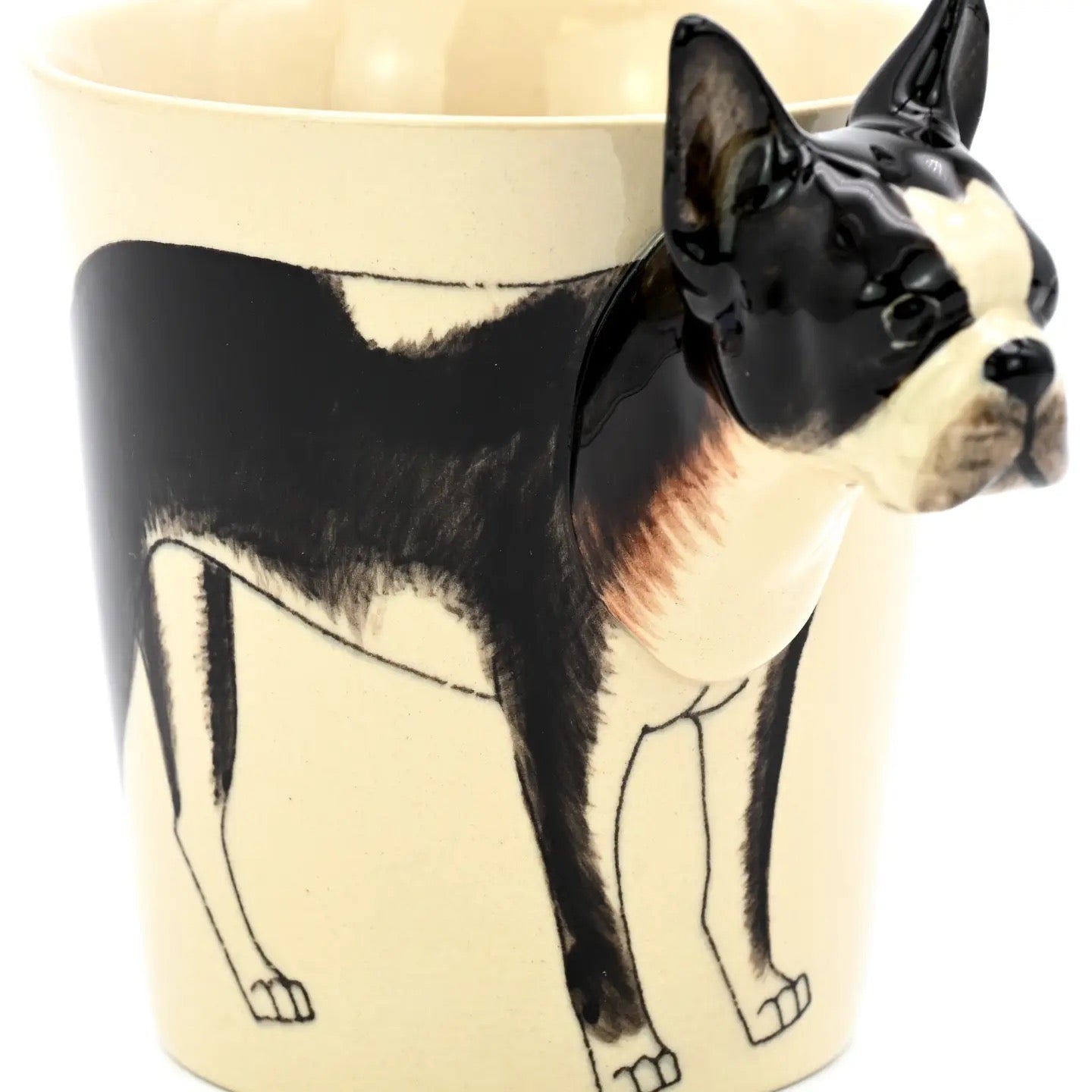 Ceramic mug with a design of a black and white dog on a beige background