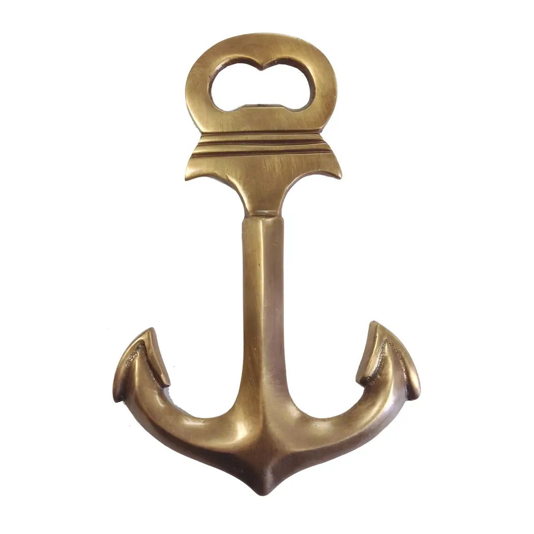 Brass anchor-shaped bottle opener on a white background