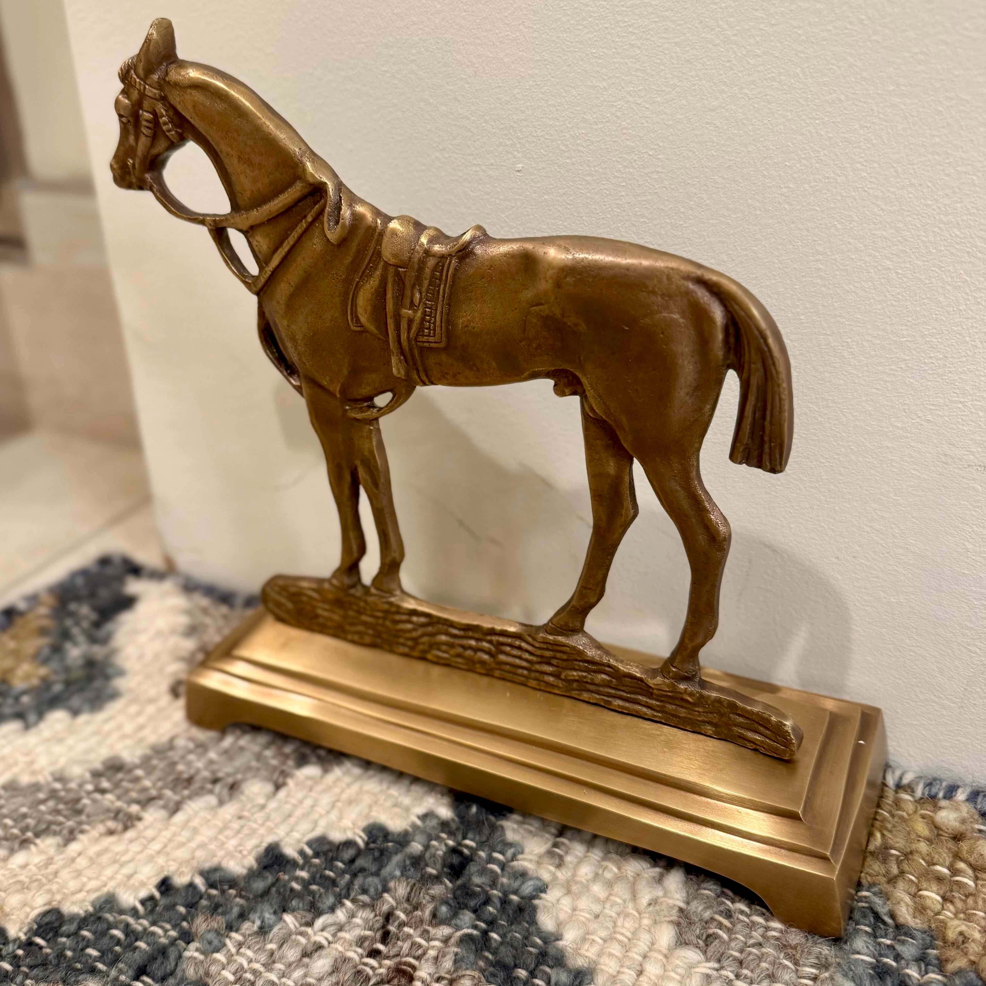 Bronze horse statue on a textured surface