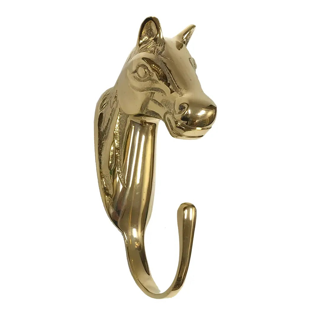 Gold horse head ring on a white background