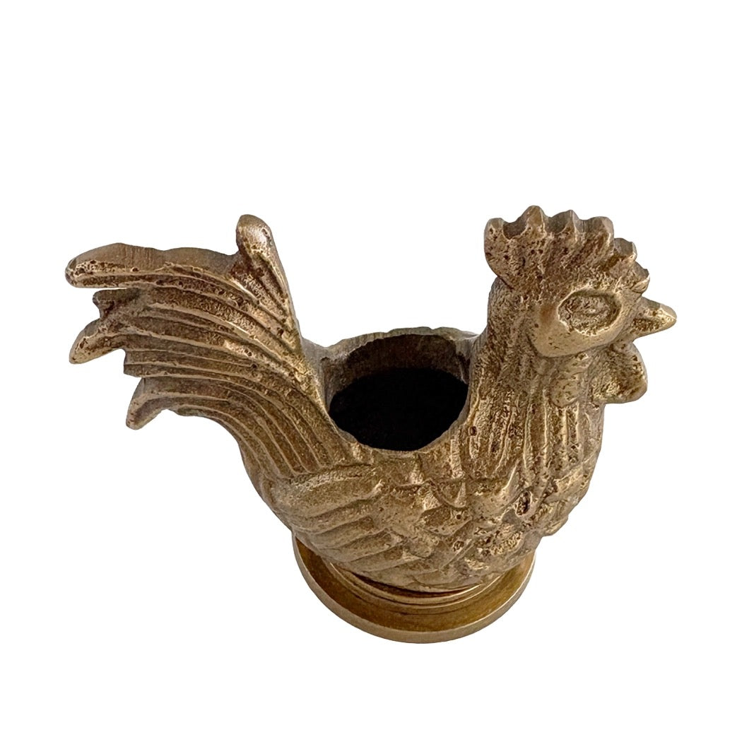 A decorative rooster-shaped metal container or holder with a textured, distressed gold finish, shown against a plain white background.