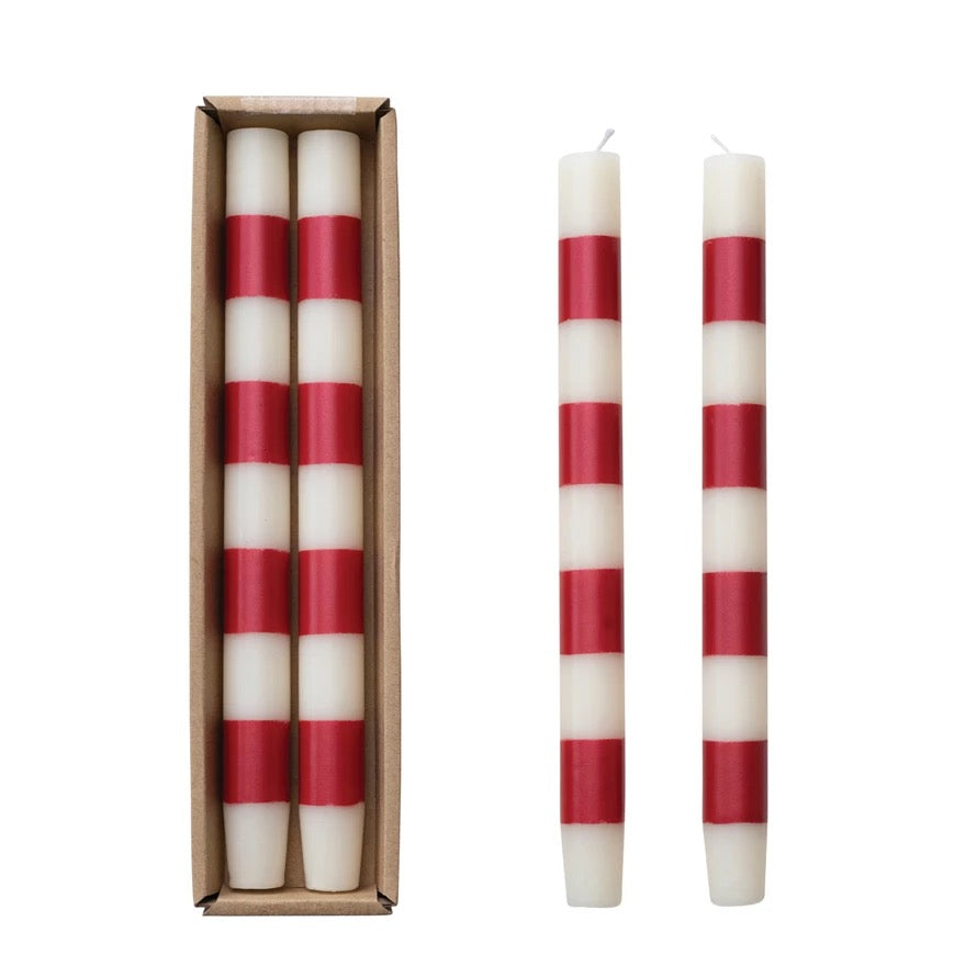 Red and white striped candles with packaging on a white background