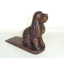Bronze dog-shaped door stopper on a white background
