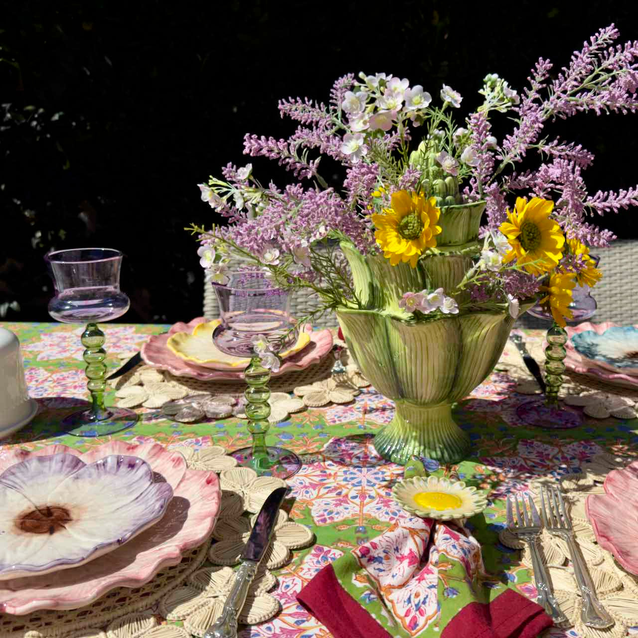 Decorative table setting with flowers and colorful tablecloth
