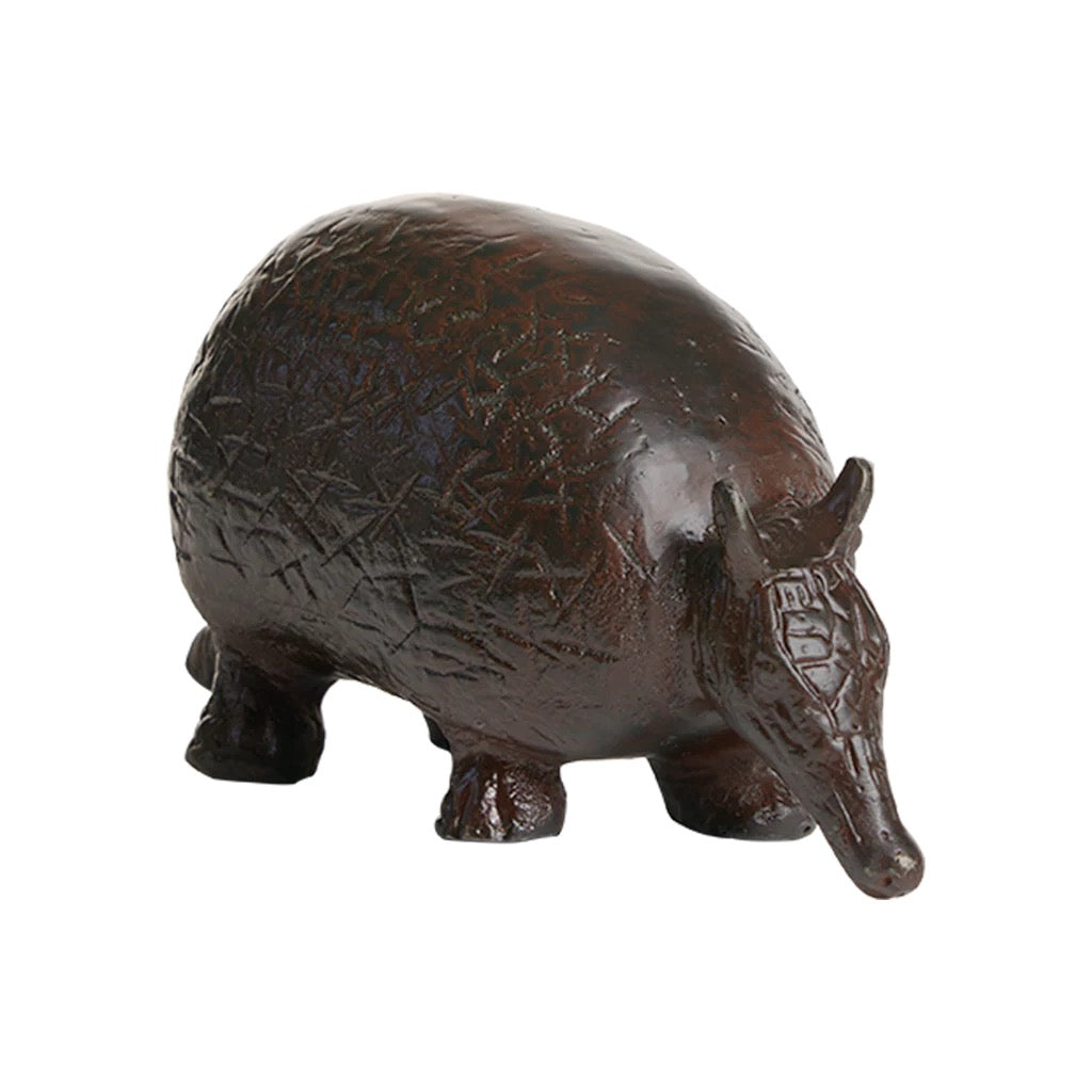 Bronze armadillo figurine on a white background