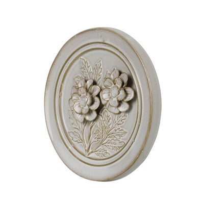 Decorative wall plate with floral design on a white background