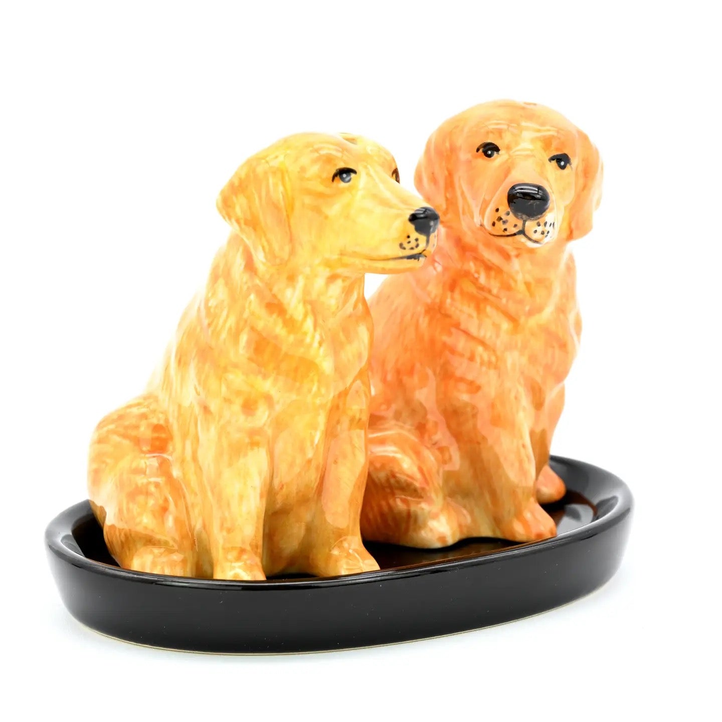 Two dog-shaped salt and pepper shakers on a black base with a white background