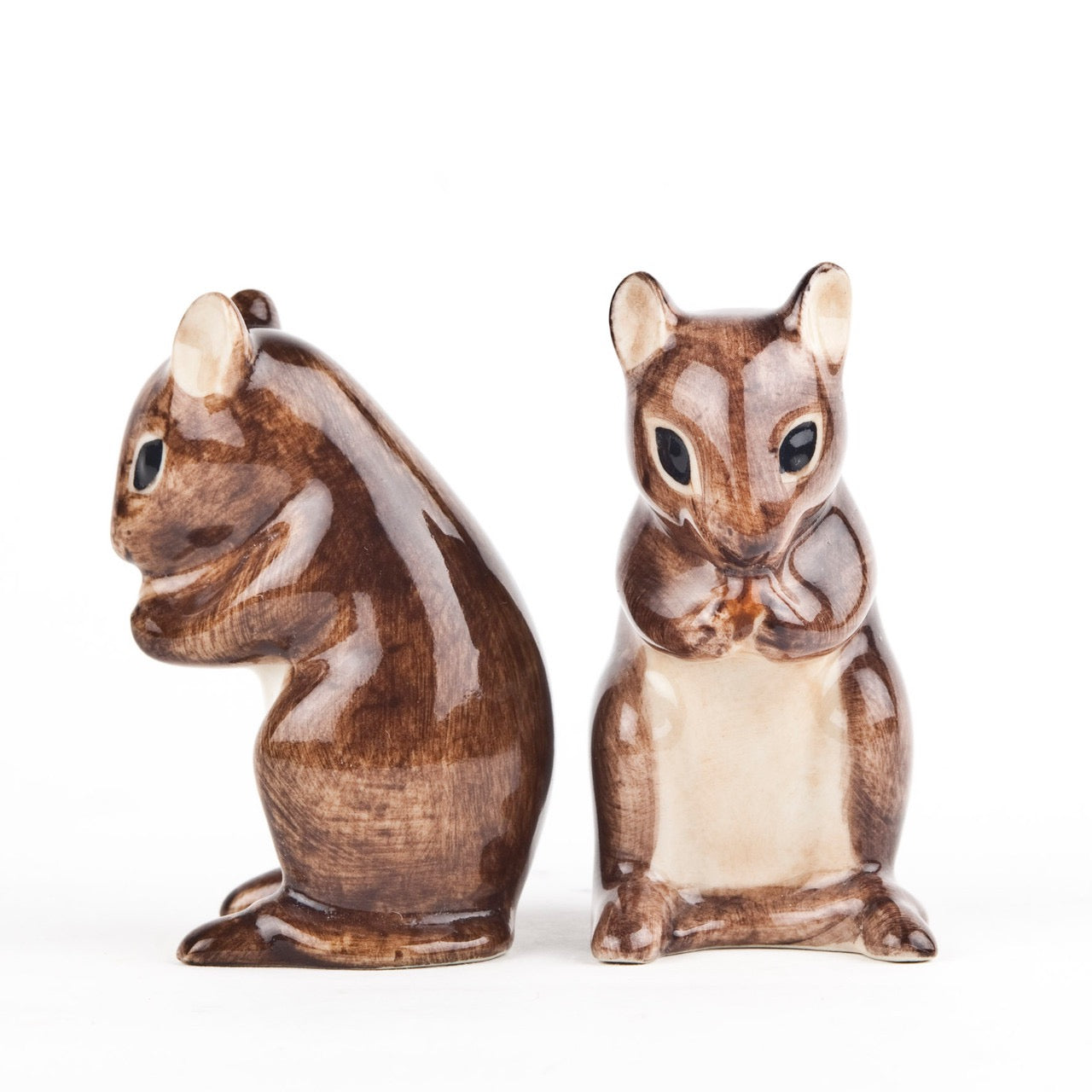 Two ceramic squirrel figurines on a white background