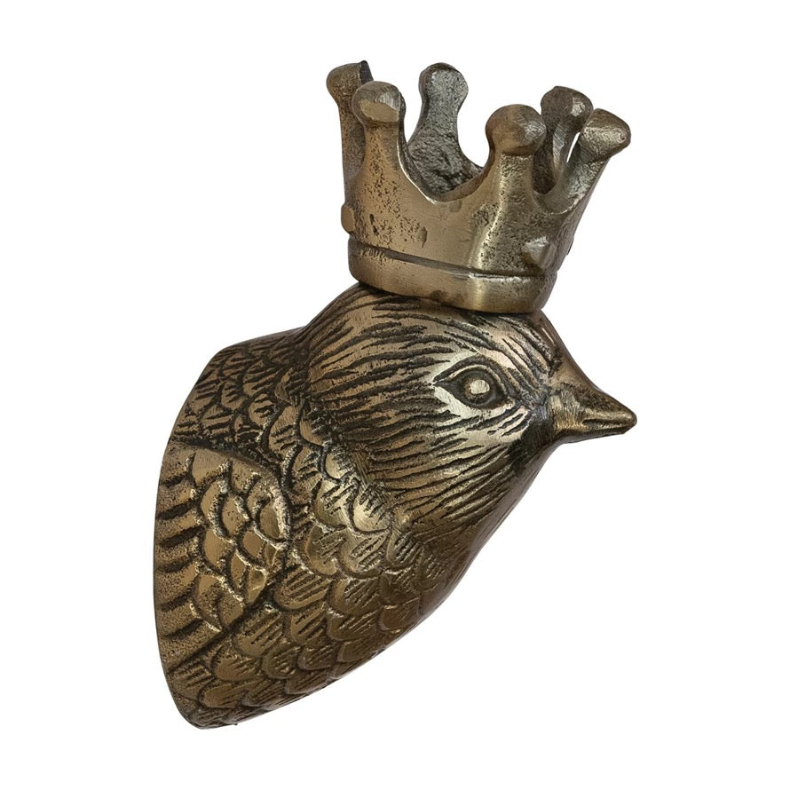 Bronze sculpture of a bird's head with a crown on a white background