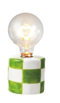 Table lamp with a checkered base and clear bulb on a white background