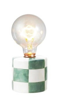 Decorative lamp with a checkered base and exposed light bulb on a white background
