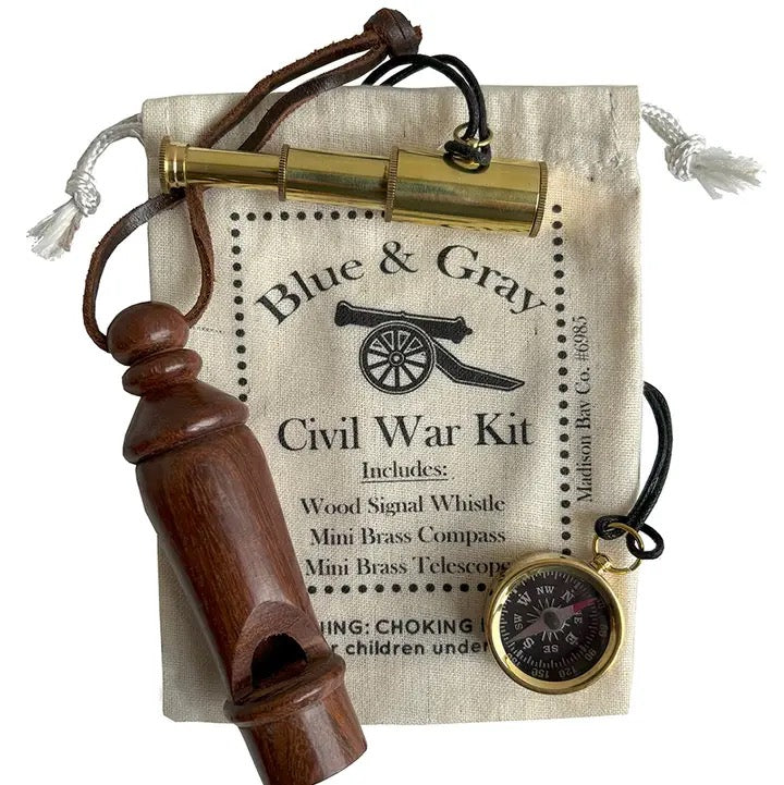 Civil War-themed kit with wooden whistle, brass compass, and telescope on a 'Blue & Gray' branded bag.