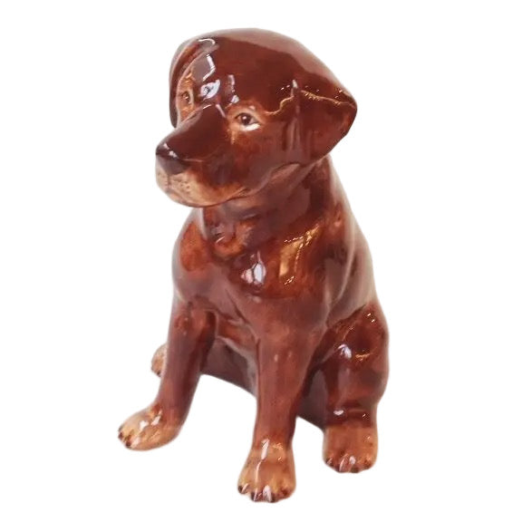 Brown ceramic dog figurine on a white background