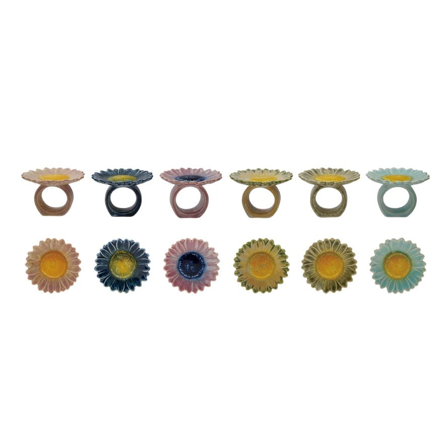 Set of colorful ceramic rings with floral designs on a white background