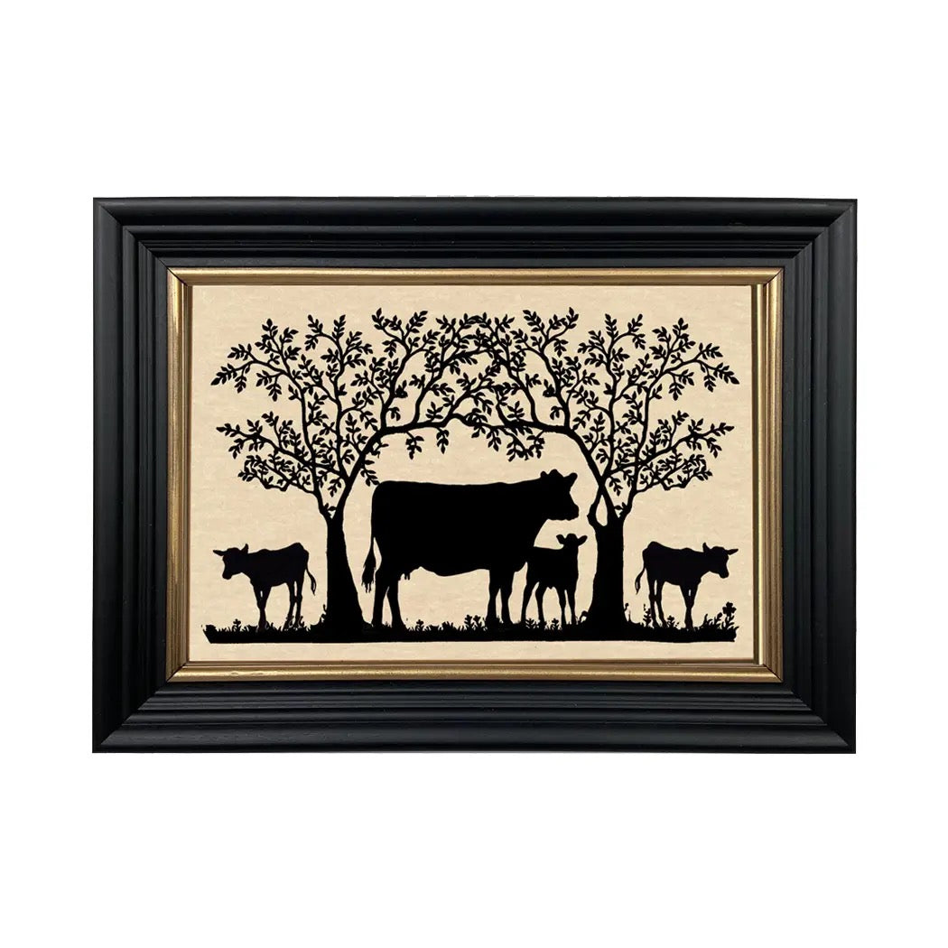 Framed artwork with black silhouettes of cows and trees on a beige background