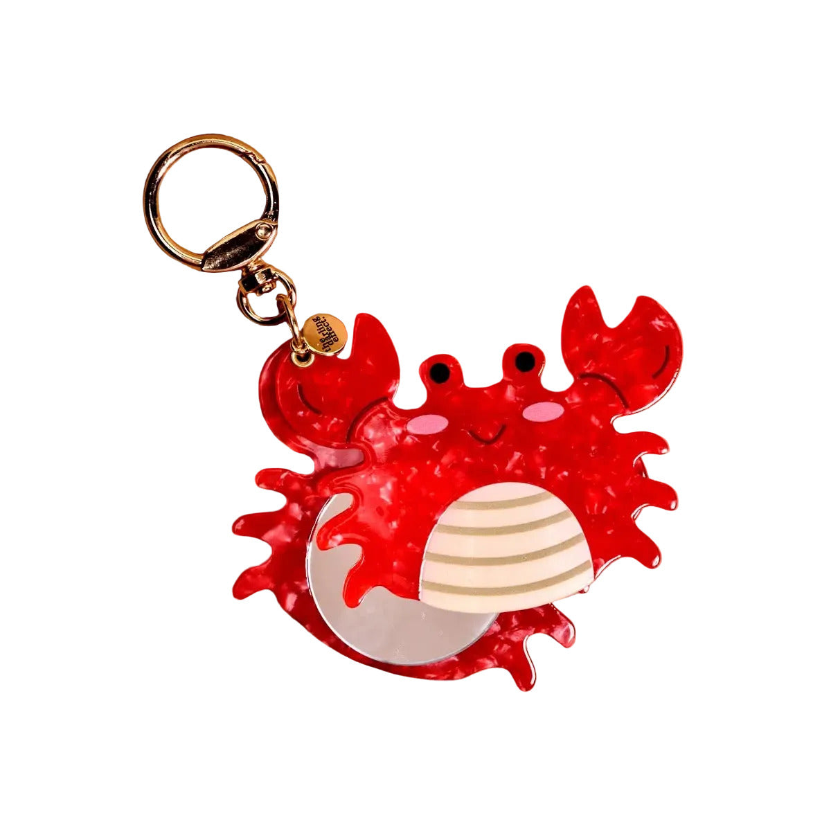 Red crab-shaped keychain on a beige background