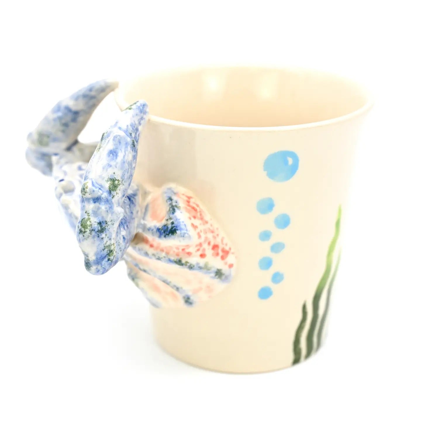 Decorative cup with floral design and blue accents on a white background