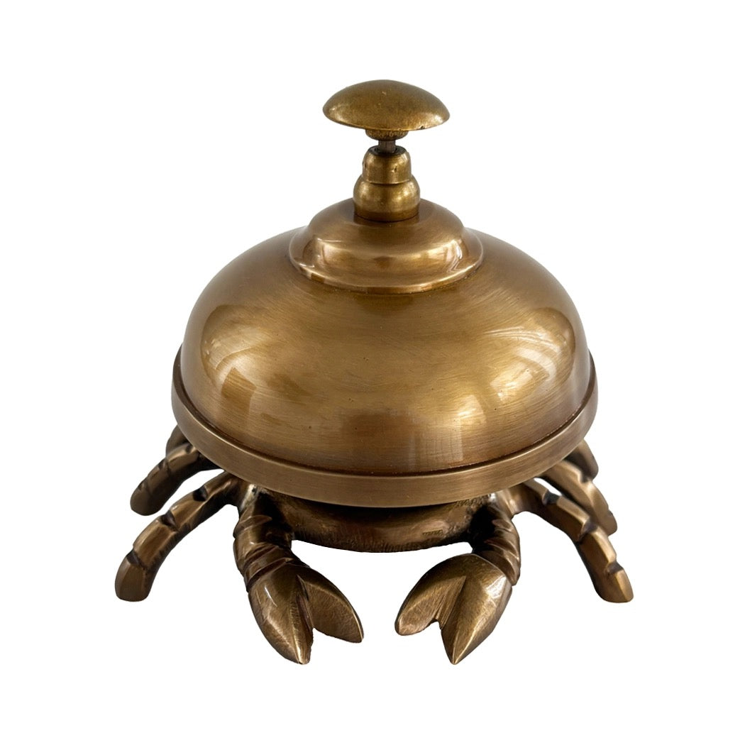 A brass lobster-shaped bellhop or waiter's station with a domed top and clawed base, shown on a plain white background.