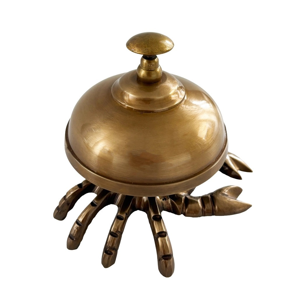 A brass lobster-shaped bellhop or waiter ornament with a domed lid and clawed base, shown on a plain white background.