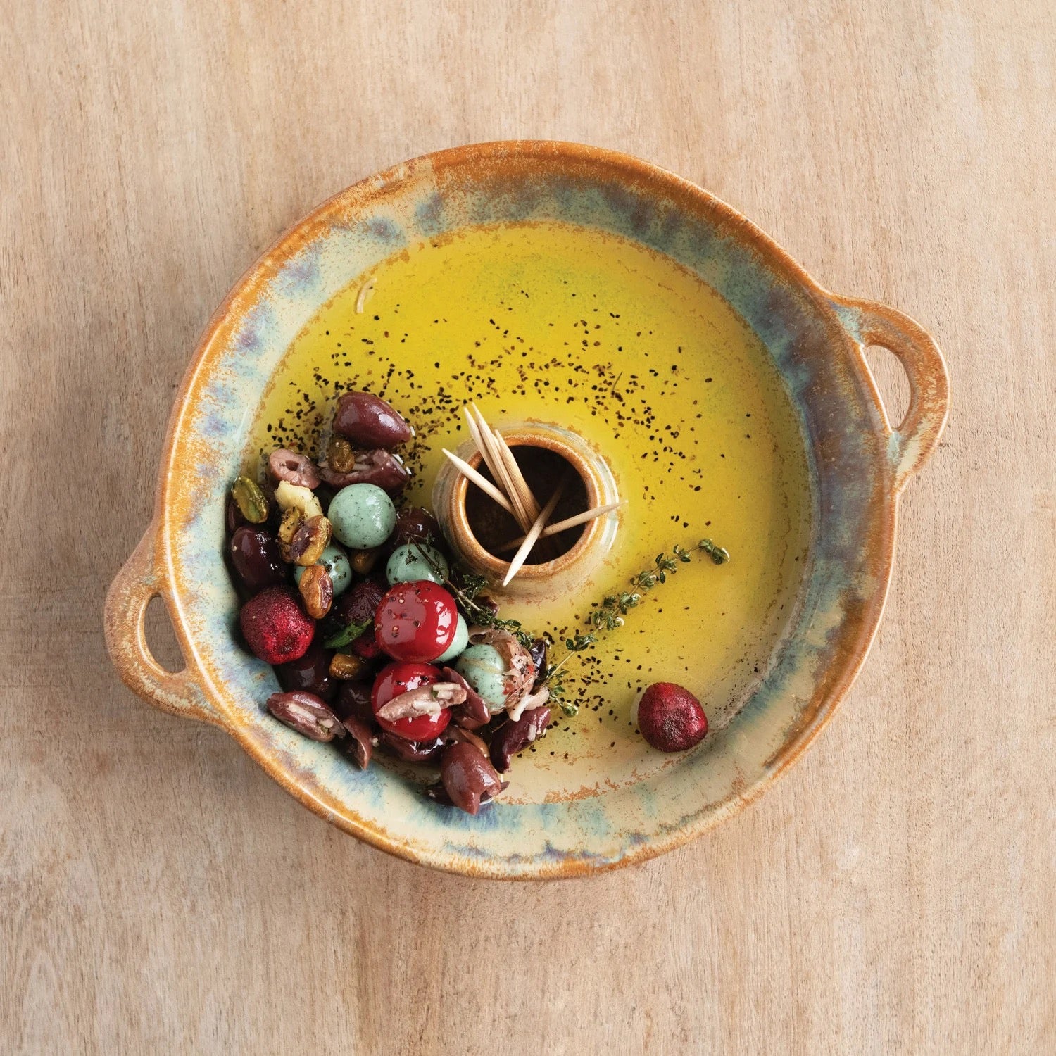 Ceramic dish with yellow sauce and garnishes on a wooden surface