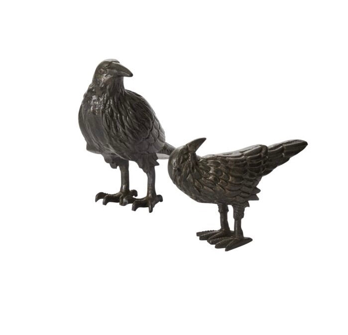 Two metal bird figurines on a white background