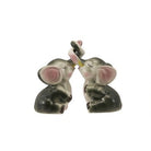 Two ceramic mouse figurines holding hands on a white background