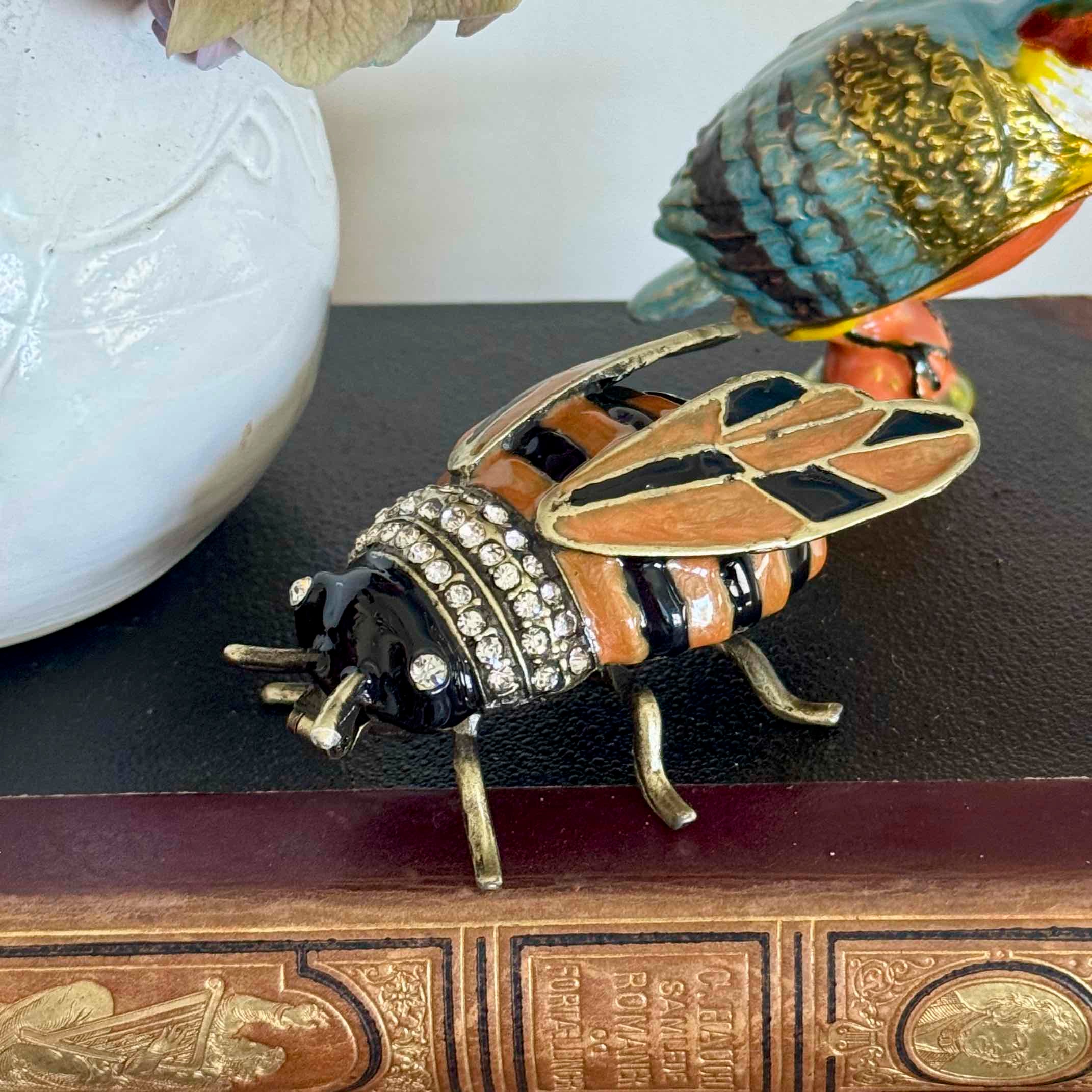 Decorative bee figurine with gemstones on a book