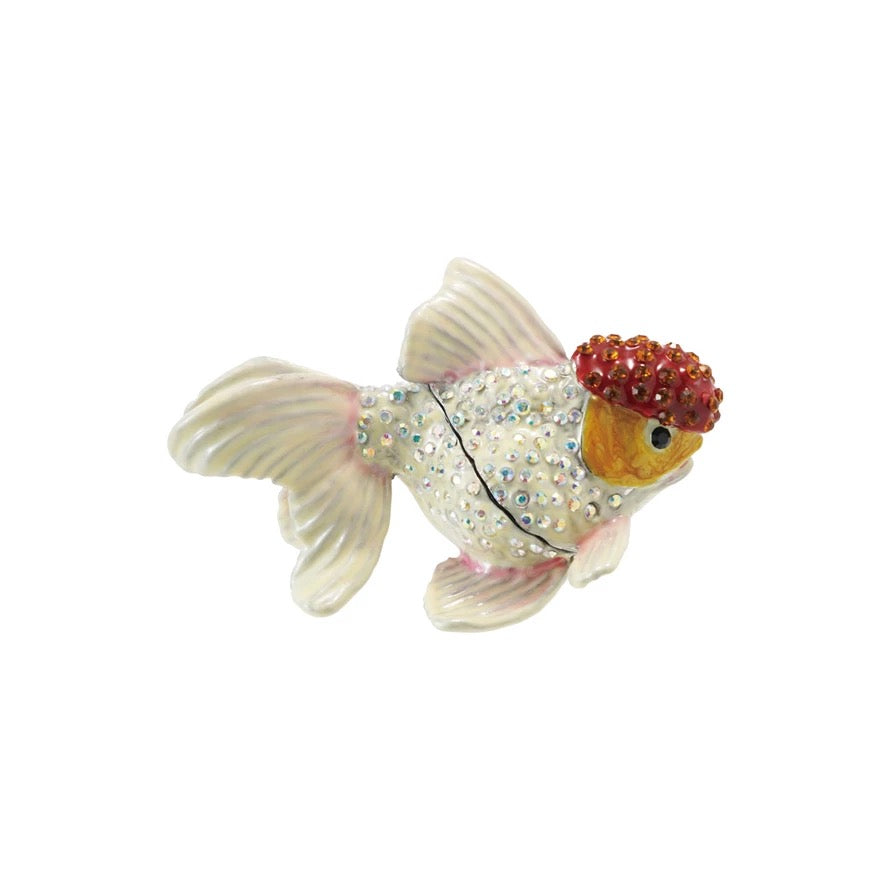 Decorative goldfish figurine with embellishments on a white background