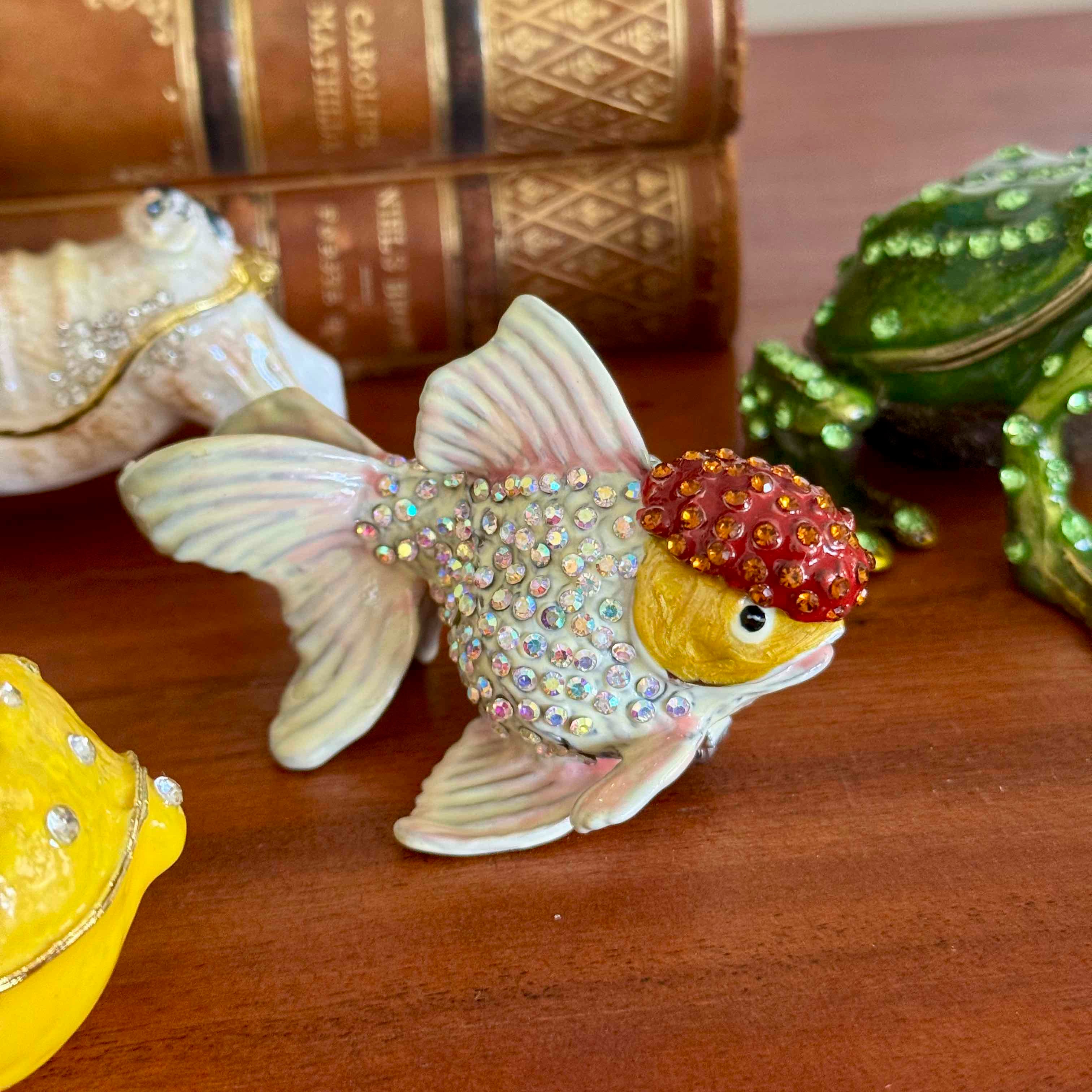 Decorative fish figurine with a crown on a wooden surface